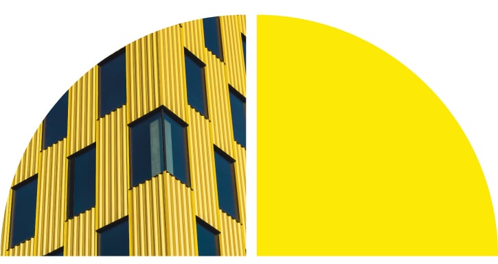 Yellow building with black windows.