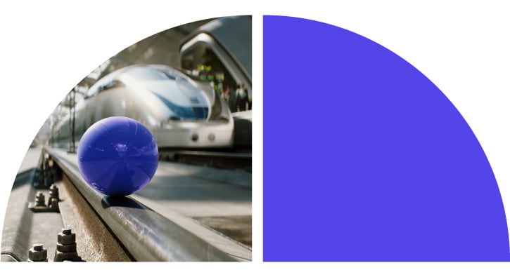 A violet ball on a train rail.